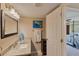 Bathroom showcasing granite countertop, modern fixtures, decorative mirror and adjacent bedroom view at 217 S Mcmullen Booth Rd # 179, Clearwater, FL 33759