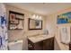 Bathroom featuring granite vanity, decorative towels, and a well-lit mirror at 217 S Mcmullen Booth Rd # 179, Clearwater, FL 33759