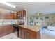 Updated kitchen featuring modern appliances, dark wood cabinets, and a breakfast bar for casual dining at 217 S Mcmullen Booth Rd # 179, Clearwater, FL 33759