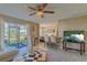 Inviting living room with ceiling fan, tile flooring, and sliding glass door to outdoor patio at 217 S Mcmullen Booth Rd # 179, Clearwater, FL 33759