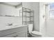 A well lit bathroom features a gray vanity, sink, and tiled shower and tub combination at 2195 Glen Dr, Safety Harbor, FL 34695