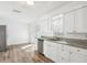 Bright kitchen featuring granite counters, stainless steel dishwasher, and sleek white cabinets at 2195 Glen Dr, Safety Harbor, FL 34695