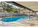 The screened in pool area features a beautiful in-ground pool with an enclosed space and patio area at 2195 Glen Dr, Safety Harbor, FL 34695