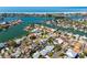 Breathtaking aerial view of waterfront property near the beach, surrounded by lush landscaping at 230 Julia S Cir, St Pete Beach, FL 33706