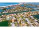 Stunning aerial view of waterfront community with houses, canals, and beautiful ocean vistas at 230 Julia S Cir, St Pete Beach, FL 33706