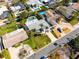 Aerial view of the property with pool, landscaping, driveway and surrounding neighborhood at 230 S Julia Cir, St Pete Beach, FL 33706