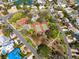 Aerial view of the neighborhood featuring tennis courts, winding roads and mature trees at 230 S Julia Cir, St Pete Beach, FL 33706