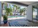 Beautiful backyard with a covered patio overlooking a pool surrounded by palm trees at 230 Julia S Cir, St Pete Beach, FL 33706