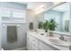 Bright bathroom with double sinks, a large mirror, and a neutral color scheme at 230 Julia S Cir, St Pete Beach, FL 33706