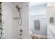 Modern bathroom with updated fixtures, white tile, and a shower/bath combination at 230 Julia S Cir, St Pete Beach, FL 33706