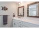 Bathroom featuring new white cabinets and a framed mirror at 230 Julia S Cir, St Pete Beach, FL 33706