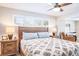 Cozy bedroom featuring a ceiling fan, wood floors, and natural light at 230 S Julia Cir, St Pete Beach, FL 33706