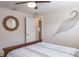 Bedroom featuring a wooden bed, ceiling fan, decorative accents, and an open doorway at 230 Julia S Cir, St Pete Beach, FL 33706