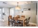 Dining room features a wooden table with seating for six and a stylish light fixture at 230 S Julia Cir, St Pete Beach, FL 33706