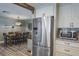 Open kitchen next to stainless steel refrigerator with dining room table in the background at 230 S Julia Cir, St Pete Beach, FL 33706