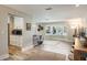 Bright living room features a bay window with plantation shutters and wood-look tile flooring at 230 Julia S Cir, St Pete Beach, FL 33706