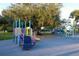 Fun community playground with climbing structures, slides and swings surrounded by lush green space at 230 Julia S Cir, St Pete Beach, FL 33706