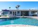 Backyard pool with comfortable seating and a lovely view of the home's exterior at 230 Julia S Cir, St Pete Beach, FL 33706