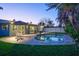 Backyard swimming pool with patio, lounge chairs and tropical landscaping at 230 Julia S Cir, St Pete Beach, FL 33706