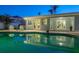 Sparkling swimming pool reflecting the home's exterior and patio area at 230 S Julia Cir, St Pete Beach, FL 33706