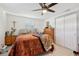 Bedroom featuring a dresser, bed with blanket and decorative accessories at 2419 Palmwood Dr, Holiday, FL 34690