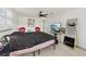 Brightly lit bedroom with two windows, a TV and a black bedspread at 2419 Palmwood Dr, Holiday, FL 34690