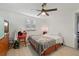 Bedroom with a ceiling fan and light wood floors, offering a comfortable space at 2419 Palmwood Dr, Holiday, FL 34690