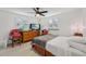 Bedroom with TV, ceiling fan, natural light from window, and modern decor at 2419 Palmwood Dr, Holiday, FL 34690