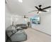 Comfortable living room with a large gray sectional sofa and modern ceiling fans at 2419 Palmwood Dr, Holiday, FL 34690