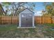 New storage shed in the backyard, with a secure door and clean design at 2419 Palmwood Dr, Holiday, FL 34690