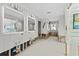 Bright bathroom with large mirrors, modern lighting, and views of the water from a window at 2630 W Bay Isle Se Dr, St Petersburg, FL 33705