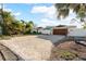 Modern home with a large paver driveway, a two-car garage, and a well-maintained front yard at 2630 W Bay Isle Se Dr, St Petersburg, FL 33705