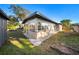 View of the backyard featuring a well-kept lawn, perimeter of white rocks and a partially fenced perimeter at 2905 Bay St, Sarasota, FL 34237