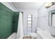 Renovated bathroom featuring green tiled shower and updated vanity at 2905 Bay St, Sarasota, FL 34237