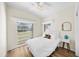 Light bedroom features wood floors, a large window, and bright white furnishings, maximizing space at 2905 Bay St, Sarasota, FL 34237