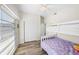 Bright bedroom featuring wood floors, window, closet, and bunk beds, combining comfort and utility at 2905 Bay St, Sarasota, FL 34237