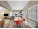 Bright dining room featuring wood-look floors, wainscotting, and a modern dining set with views to a sitting area at 2905 Bay St, Sarasota, FL 34237