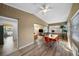 Bright dining room featuring wood-look floors, wainscotting, and a modern dining set with views to a sitting area at 2905 Bay St, Sarasota, FL 34237