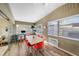 Bright dining room featuring wood-look floors, wainscotting, and a modern dining set with views to a sitting area at 2905 Bay St, Sarasota, FL 34237