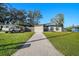 Attractive single-Gathering home with a long driveway, lush green lawn, and mature trees at 2905 Bay St, Sarasota, FL 34237