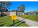 Charming single-story home featuring a well-manicured lawn and a inviting walkway leading to the front door at 2905 Bay St, Sarasota, FL 34237