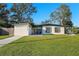 Quaint single-Gathering home featuring a lush front lawn and freshly painted front door with stylish shutters at 2905 Bay St, Sarasota, FL 34237