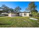 Beautiful single-story home with a well-kept lawn, mature trees, and attractive landscaping at 2905 Bay St, Sarasota, FL 34237