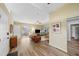 Inviting living room with wood floors, neutral paint, ceiling fan, and view to a sunroom in a comfortable home at 2905 Bay St, Sarasota, FL 34237