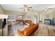 Open living space with wood-look floors, ceiling fans, neutral paint, and a view into the dining/sun room at 2905 Bay St, Sarasota, FL 34237