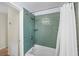 Updated bathroom featuring green tiled shower and updated hardware at 2905 Bay St, Sarasota, FL 34237