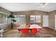 Enclosed sunroom featuring a large dining table, bright chairs, and wood-look flooring at 2905 Bay St, Sarasota, FL 34237