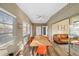 Bright sunroom featuring wood-look flooring, bright chairs, and access to the living room at 2905 Bay St, Sarasota, FL 34237