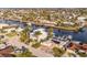 Aerial view of waterfront community with canal access and houses with backyard pools and boat docks at 3939 Rudder Way, New Port Richey, FL 34652