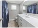 Bathroom with white vanity, brushed nickel hardware and large mirror at 3939 Rudder Way, New Port Richey, FL 34652